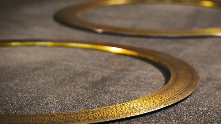 A steel and gold quoit.